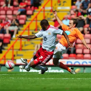 Bristol City vs Blackpool: Marvin Elliott's Battle for the Ball - Championship Football Match, 2010