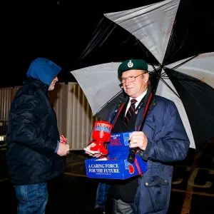 Bristol City's Buster Footman Collects Donations in the Rain
