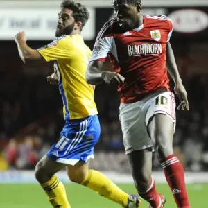 Bristol City's Jay Emmanuel-Thomas Outmaneuvers Brentford's Will Grigg in Sky Bet League One Clash