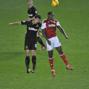 Bristol City's Jay Emmanuel-Thomas Soars Above Crawley Town's Joe Walsh in Intense Football Clash Bristol City's Jay Emmanuel-Thomas Soars Above Crawley Town's Joe Walsh in Intense Football Clash