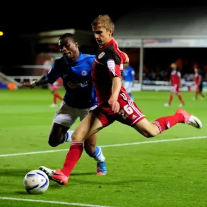 Bristol City's Joe Bryan Outmaneuvers Gabriel Zakuani of Peterborough United in Championship Clash Bristol City's Joe Bryan Outmaneuvers Gabriel Zakuani of Peterborough United in Championship Clash