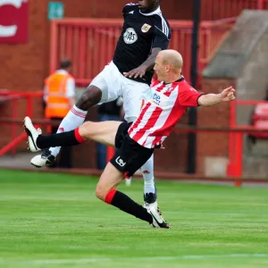 Bristol Citys John Akinde battles for the ball with Rob Edwards