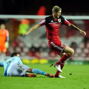 Bristol City's Jon Stead Slips Past Corry Evans of Hull City in Championship Clash Bristol City's Jon Stead Slips Past Corry Evans of Hull City in Championship Clash