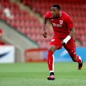 Bristol City's Kodjia Chases Down the Ball in Preseason Clash against Cheltenham Town