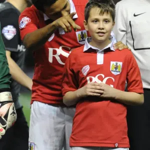 Bristol City's Korey Smith and the mascot celebrate a win in print Bristol City's Korey Smith and the mascot celebrate a win in print