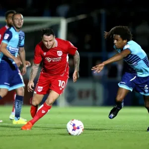 Bristol City's Lee Tomlin Dashes Past Wycombe Wanderers Sido Jombati in EFL League Cup Clash