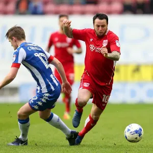 Bristol City's Lee Tomlin Faces Off Against Wigan Athletic's Callum Connolly in Championship Clash