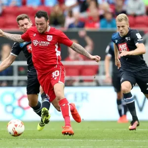 Bristol City's Lee Tomlin Outmaneuvers Derby County's Bryson and Vydra