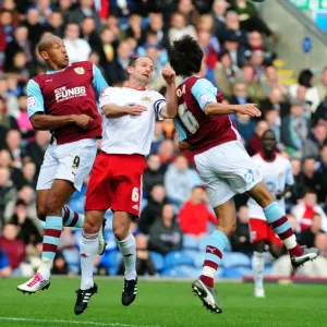 Bristol City's Louis Carey Battles for Aerial Ball Against Burnley's Iwelumo and Cork in Championship Match, 2010 Bristol City's Louis Carey Battles for Aerial Ball Against Burnley's Iwelumo and Cork in Championship Match, 2010