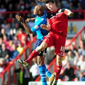 Bristol City's Martyn Woolford Outmuscles Rodolph Austin for the Header in Championship Clash against Leeds United