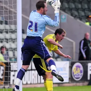 Bristol Citys Neil Kilkenny challenges Plymouth goalkeeper Bristol Citys Neil Kilkenny challenges Plymouth goalkeeper