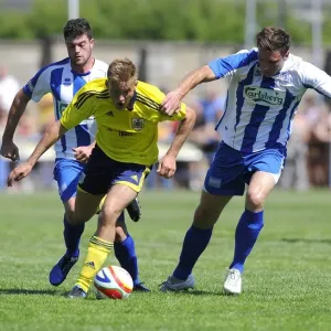 Bristol City's Rhys Jordan Fights for Possession Against Clevedon Town Defense in Pre-Season Friendly Bristol City's Rhys Jordan Fights for Possession Against Clevedon Town Defense in Pre-Season Friendly