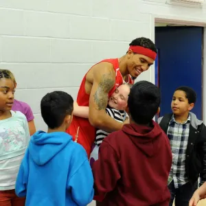 Bristol Flyers Basketball: Greg Streete Embraces Young Fan Amidst Cheers at Wise Campus Bristol Flyers Basketball: Greg Streete Embraces Young Fan Amidst Cheers at Wise Campus