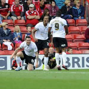 Celebrating the Goal: Barnett, Assombalonga, and Tomlin of Peterborough United at Ashton Gate after Scoring against Bristol City (September 14, 2013)