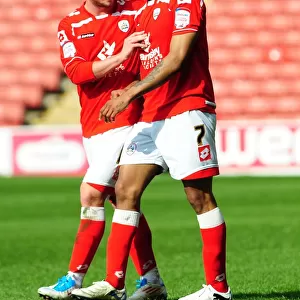 Celebration: Barnsley's Haynes and Butterfield Rejoice in Championship Victory over Bristol City (09/04/2011)