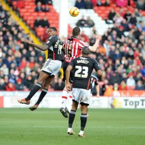 Clash at Bramall Lane: Jay Emmanuel-Thomas Battles Neil Collins for Aerial Supremacy in Sheffield United vs. Bristol City Football Match, 2014 Clash at Bramall Lane: Jay Emmanuel-Thomas Battles Neil Collins for Aerial Supremacy in Sheffield United vs. Bristol City Football Match, 2014