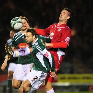 Clash in the Championship: Stefan Maierhofer of Bristol City Battles Karl Duguid of Plymouth Argyle for an Aerial Ball Clash in the Championship: Stefan Maierhofer of Bristol City Battles Karl Duguid of Plymouth Argyle for an Aerial Ball