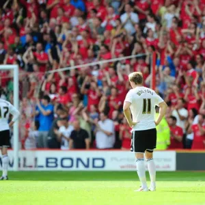 Dejected Bristol City Players as Nottingham Forest Celebrate Championship Victory