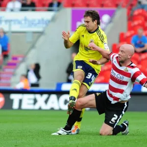 Print of Doncaster Rovers player James O'Connor in a tackle