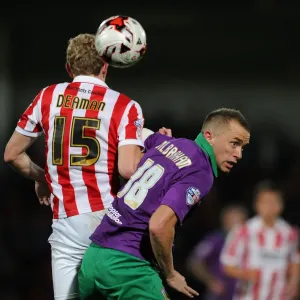 Intense Rivalry: Wilbraham vs Deaman - The Battle for the Ball in Cheltenham Town vs Bristol City Football Match, October 2014