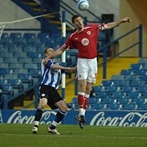Jamie McCombe climes above the sheffield wednesday front line