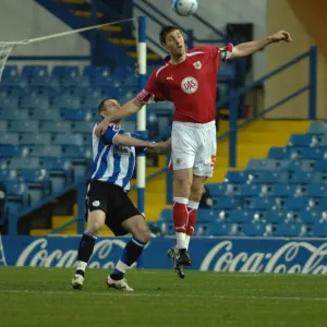 Jamie McCombe climes above the sheffield wednesday front line
