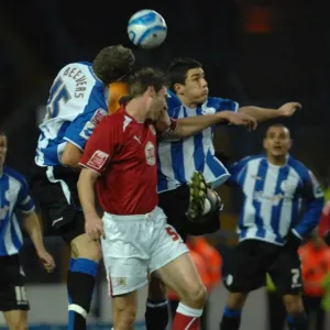 Jamie McCombe jumps to compete with the sheffield wednesday defence