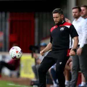 Print of Lee Johnson kicking the ball at Scunthorpe United