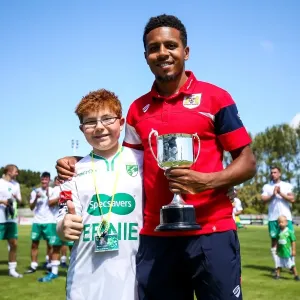 Korey Smith Receives Trophy after Guernsey's Defeat to Bristol City (0-1) Korey Smith Receives Trophy after Guernsey's Defeat to Bristol City (0-1)