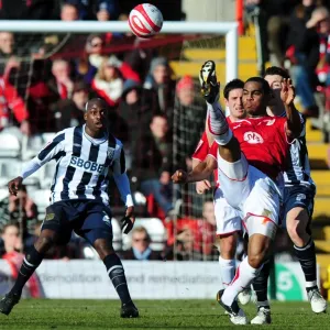 Marvin Elliott Clears Ball from Robert Koren: A Pivotal Moment in the 2010 Football Championship Clash between Bristol City and West Bromwich Albion