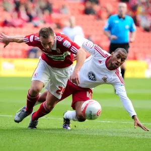 Middlesbroughs Tony McMahon battles for the ball with Bristol Citys Danny Haynes