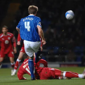 Nicky Maynard slides in on Gareth McAuley