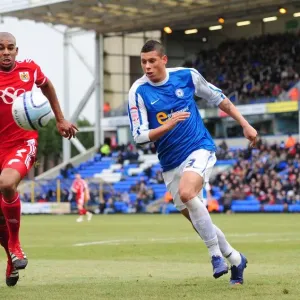 Race for the Ball: Briggs vs. Elliott in Peterborough United vs. Bristol City Football Match