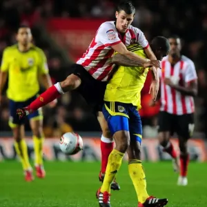 Print of Morgan Schneiderlin fouling Marvin Elliott in a Championship match Print of Morgan Schneiderlin fouling Marvin Elliott in a Championship match