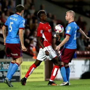 Print of Tammy Abraham vs Neil Bishop in EFL Cup action at Glanford Park