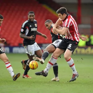 Tyrone Barnett vs. Harry Maguire: Intense Battle for the Ball in Sheffield United vs. Bristol City Football Match, 2014 Tyrone Barnett vs. Harry Maguire: Intense Battle for the Ball in Sheffield United vs. Bristol City Football Match, 2014