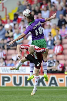 Images Dated 9th August 2014: Aaron Wilbraham Outmuscles Craig Alcock: Thrilling Header Clash in Sheffield United vs