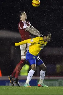 Bristol City V Coventry City Prints: Aden Flint vs. Nathan Delfouneso: Intense Battle for the Ball at Ashton Gate