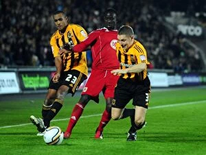 Images Dated 18th December 2010: Adomah Slips Past Simpson and Dawson: Hull City vs. Bristol City Championship Clash (18/12/2010)
