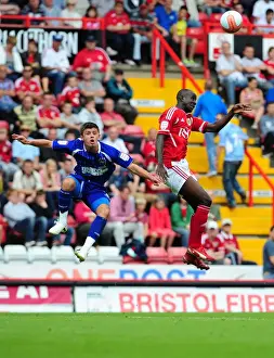 Bristol City V Ipswich Town Prints: Adomah vs. Cresswell: Intense Battle for High Ball in Bristol City vs