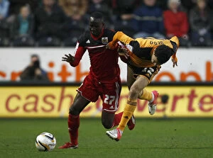 Images Dated 19th April 2013: Adomah vs Gedo: Intense Battle on the Football Field - Hull City vs Bristol City, 2013