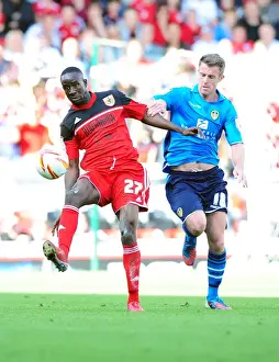 Adomah vs Tonge: Intense Battle for Ball Possession in Bristol City vs Leeds United Championship Clash