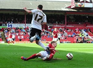 Images Dated 1st September 2012: Barnsley's John Stones Tackles Martyn Woolford in Championship Clash