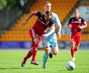 St Johnstone V Bristol City Prints: Battling for the Ball: Anderson vs. Caddis - Pre-Season Football Rivalry