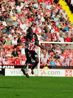 Images Dated 23rd April 2011: Battling for the Ball: Damion Stewart vs. Jordan Slew in Sheffield United vs