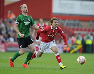 Battling for the Ball: Luke Freeman vs Neil Bishop - Football Rivalry at Ashton Gate