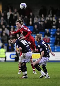 Images Dated 12th April 2011: Battling for the Ball: Woolford vs. Henry & Dunne in Millwall vs