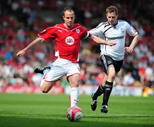 Bristol City V Derby County Prints: Battling for Championship Supremacy: Louis Carey vs Chris Porter