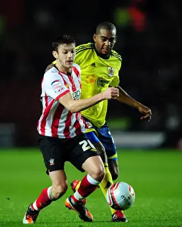 Southampton V Bristol City Prints: Battling for Championship Supremacy: Marvin Elliott vs. Adam Lallana (December 2011)