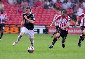 Images Dated 23rd April 2011: Battling for Championship Supremacy: Woolford vs. Montgomery - Sheffield United vs